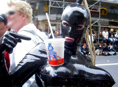 Candid action of latex enthusiasts taking part in a parade