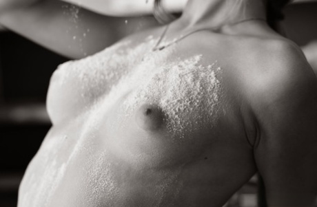 Solo girl Katia B covers her naked body in flour on a kitchen counter