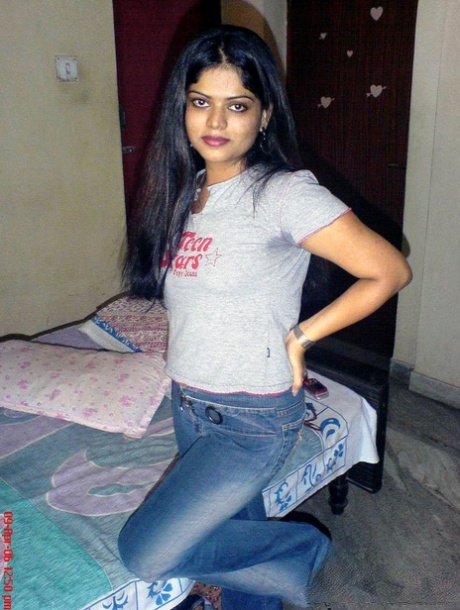 Petite Indian girl uncups big naturals after removing blue jeans