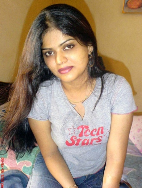 Petite Indian girl uncups big naturals after removing blue jeans