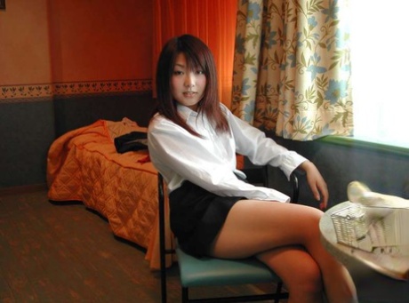 Asian first timer slowly exposes her flat chest and trimmed bush on her bed