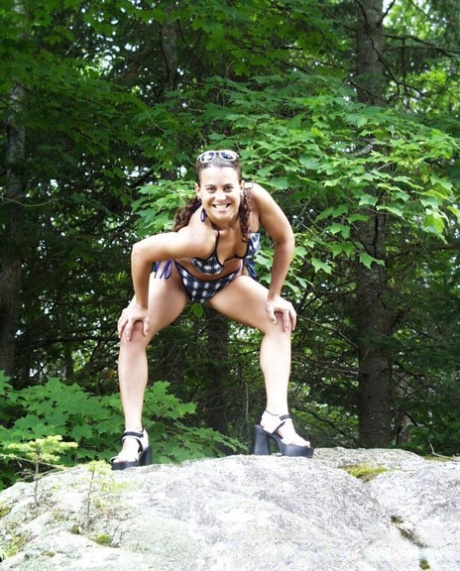 Amateur girls get naked on a boulder in the woods before lesbian play