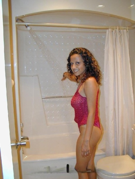 Latina girl with big tits touches her pussy while taking a shower