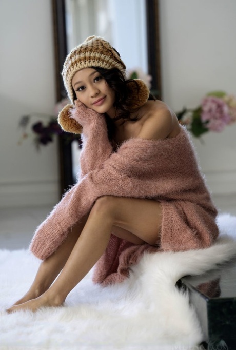 Die bezaubernde Teenagerin Jasmine Grey entledigt sich ihres Pullovers und ihres Höschens und posiert nackt in einer Wollmütze