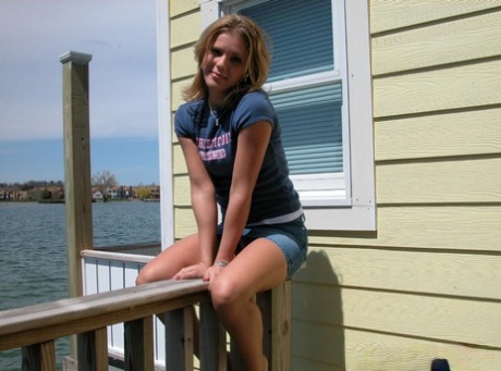Blonde solo girl flashes upskirt panties on lakeside boardwalk