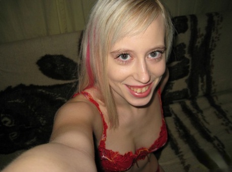 Blonde teen takes self shots while freeing her tiny tits from a red bra