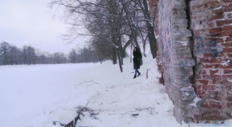 Dark-haired girl Dasha takes a badly needed piss on snowy ground