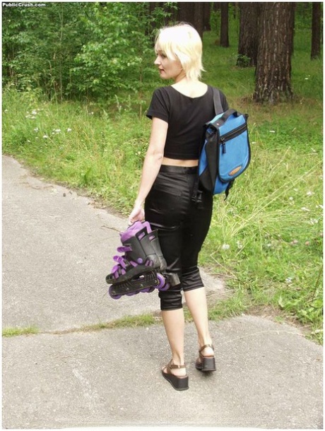 Thin blond gets naked off the side of a road while changing into roller blades