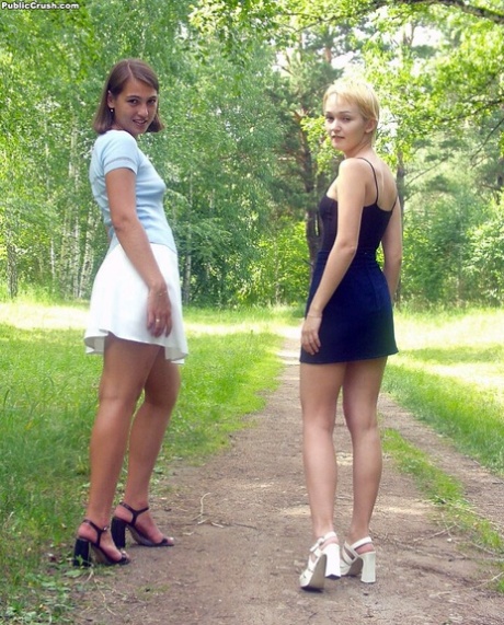 Teen lesbians exposes themselves and lick nipples while on a path in the woods