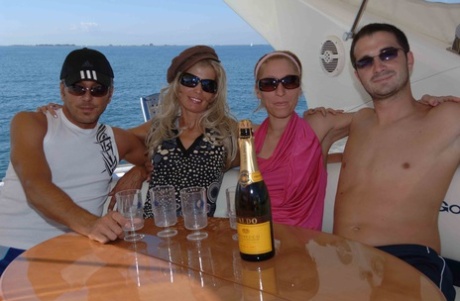 A bottle of downed wine leads to group sex action atop a boat at sea