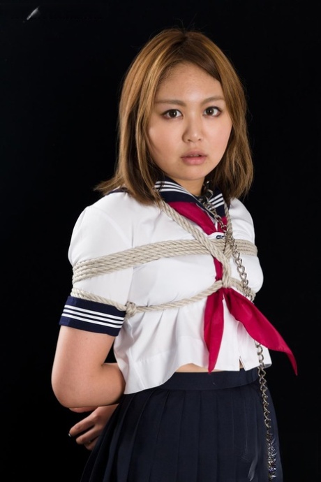 Japanese schoolgirl is forced to suck cock on her knees while rope bound