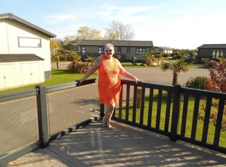 Fat nan bares her boobs while in a patio hot tub before getting naked on a bed