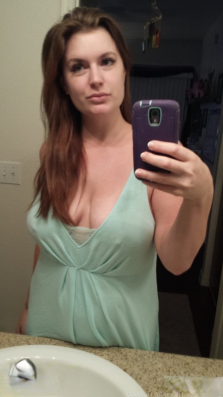 Plump amateur Danielle takes topless and clothed selfies around the house