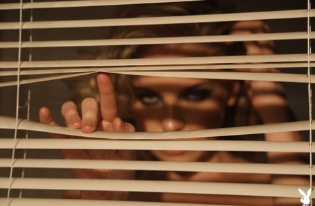 Hot blonde Kayslee Collins peers through blinds while naked in high heels