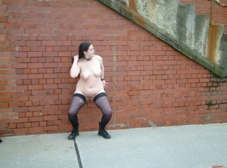 Fat British slave lets loose a stream of piss in the alley in just her nylons