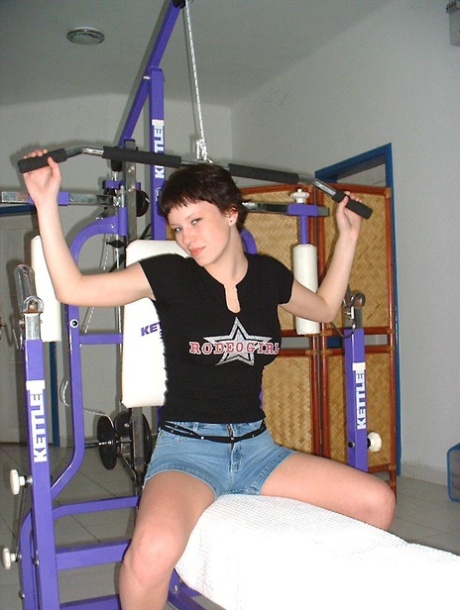 Big titted teen sports short hair while getting naked during a working out