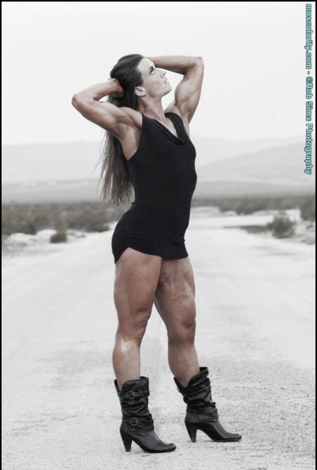 Bodybuilder Carrie Rapp models on a roadway before a weightlifting session