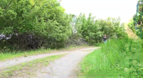 Clothed female Dafne pulls down her jeans to pee on a rural roadway