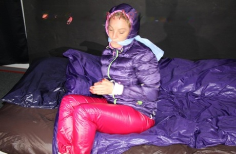 Solo girl is left gagged and tied up in a winter coat and nylon pants