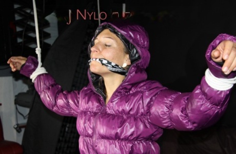 Solo girl finds herself gagged and tied up in a purple down jacket