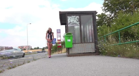 Pretty blonde Claudia Macc takes a piss while waiting to catch a bus