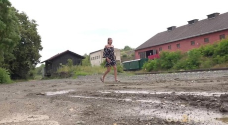 Yenna takes a piss in a puddle while wearing flip-flops