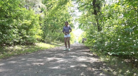 Young girl Esperansa pulls down her shorts to pee on a dirt path