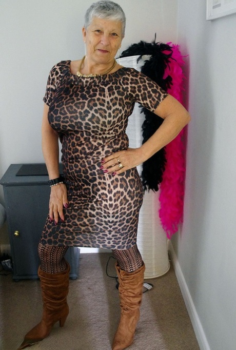 Old woman Savana doffs an animal print dress to pose nude in stockings & boots