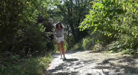 Den kaukasiska flickan Esperansa ertappas med att pissa på en stig i skogen