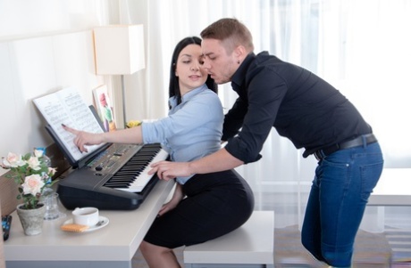 Dark haired teen hikes up her black skirt for intercourse with music tutor