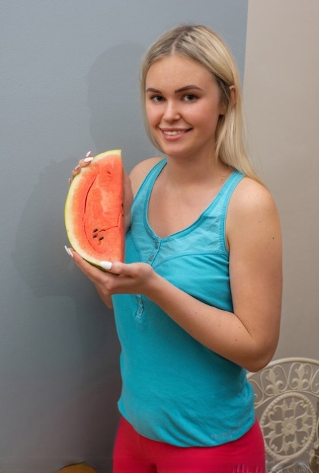 Young blonde Ruth carves up a watermelon before getting totally naked