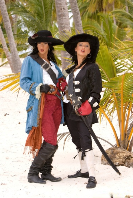 Female pirates Nikky Rider and Yvonne Peach give oral sex on a beach