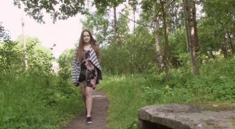 Teen girl Tanya pulls down underwear to take a pee during a walk in the woods