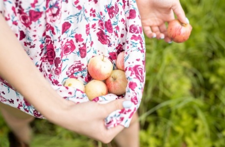 Young redheaded Agata gets naked on a blanket while picking wild apples