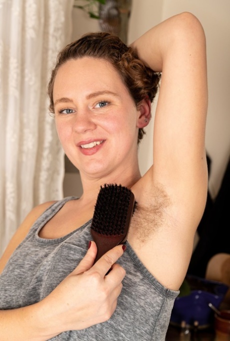 Amateur woman Lexx Lewis brushes her hairy underarms before showing her bush