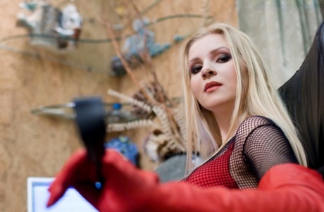 Gorgeous blonde tops a naked male slave in red boots and matching gloves