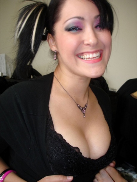 Cute Asian girl strips to a black bra and panty set in pigtails