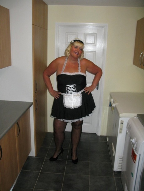 Obese blonde maid Chrissy Uk exposes herself while at work in a kitchen