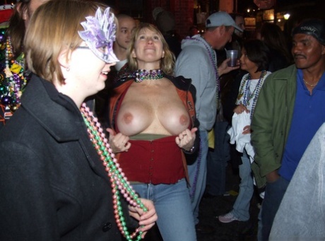Inebriated girls expose their breasts during an outdoor gathering