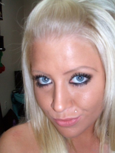 Blond meisje met opvallende ogen neemt selfies van haar stevige tieten en vagina