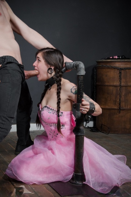 Tattooed sex slave Luna Lovely endures hard oral sex while in bondage