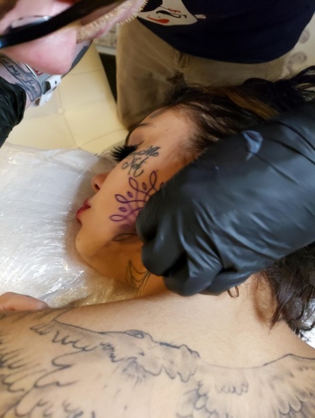 Inked female gets new artwork done while being fucked at the same time