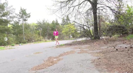 Solo girl Victoria Daniels takes a pee atop some brush beside a road