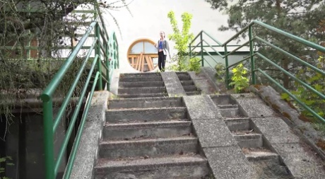 Brunette girl Elena gets caught taking a pee on a flight of concrete steps