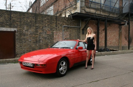 Leggy blonde Addison goes topless on a red sports car in an industrial area