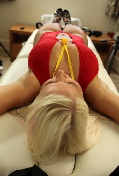 Busty blonde Sarah Jayne is strapped to a table with her pretty feet showing