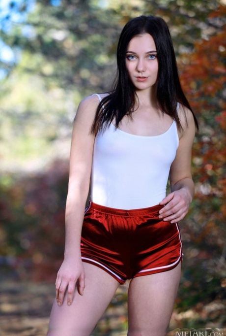 Dark-haired teen Polly Pure gets totally naked in the woods on a yoga mat