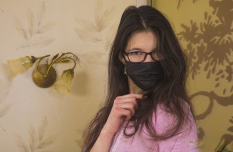 18-year-old geek Juno H doffs a face mask & clothes to pose nude in OTK socks