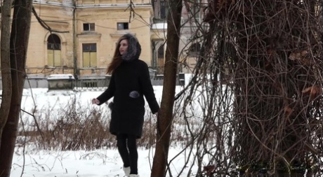 Short taken girl Vika squats for a piss on snow-covered ground in the city