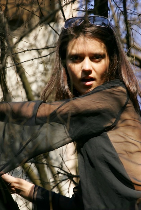 18-year-old model Roza A gets completely naked while traversing a fallen tree